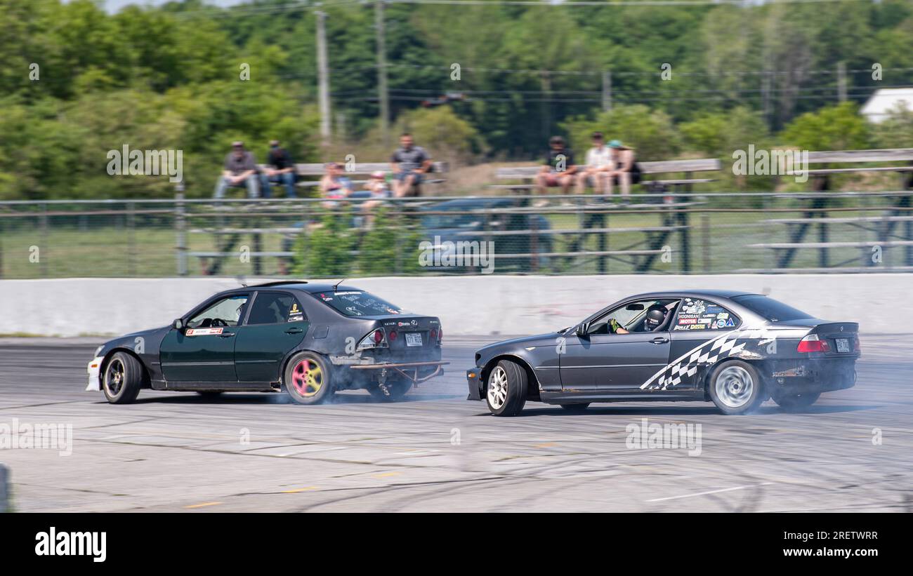 Car drifting auto racing event action with smoking tires - burning ...