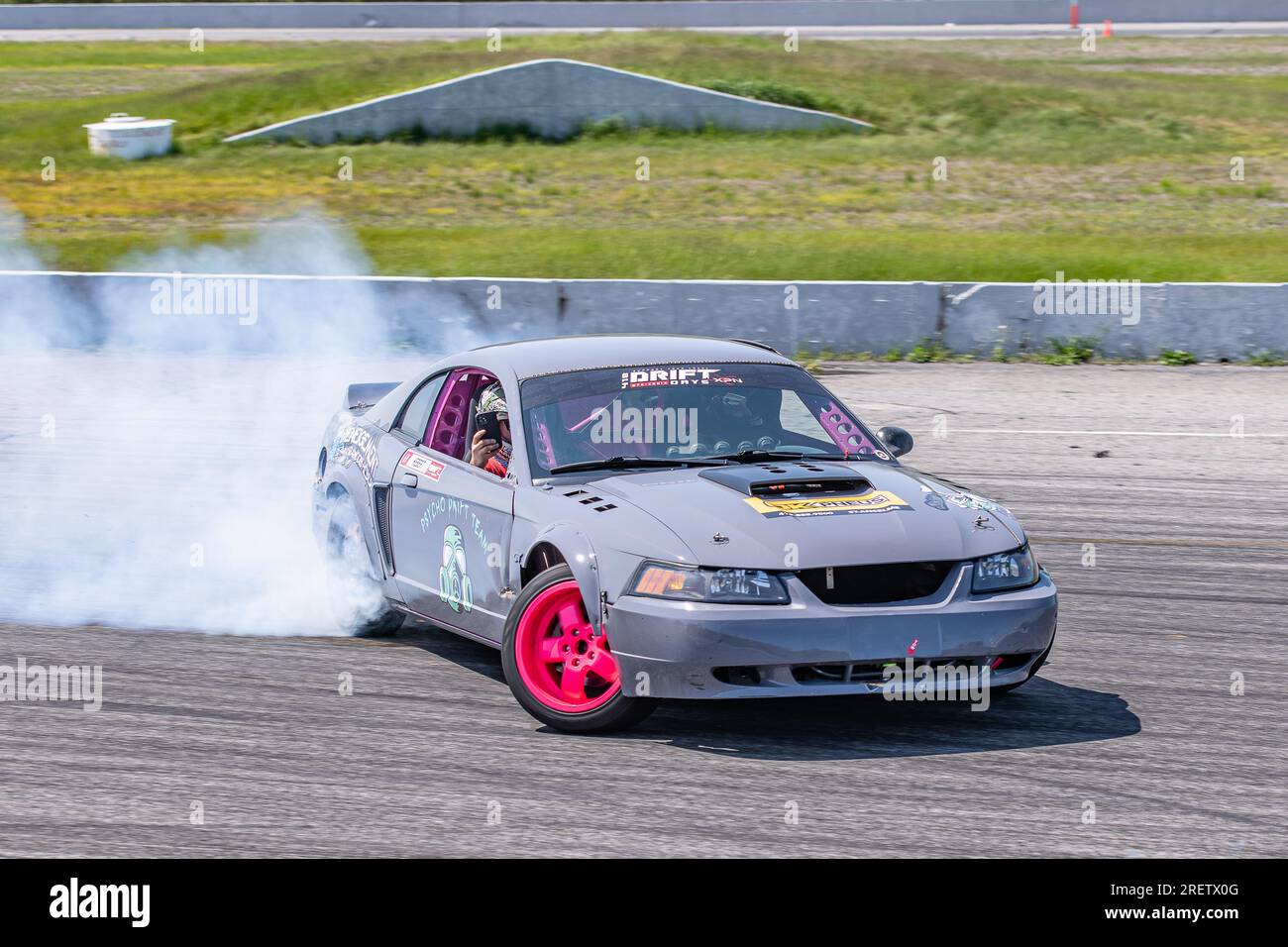 Car drifting auto racing event action with smoking tires - burning ...