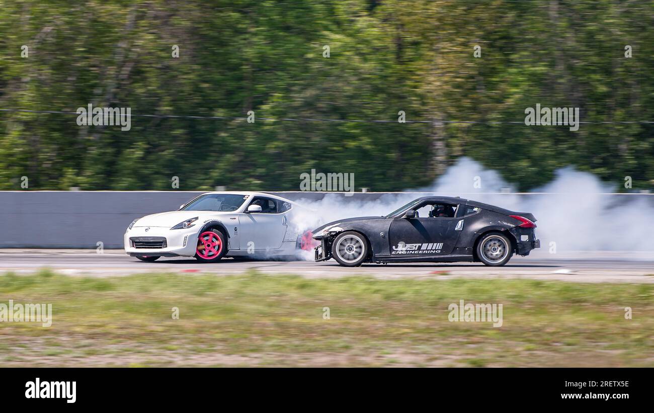 Car drifting auto racing event action with smoking tires - burning ...