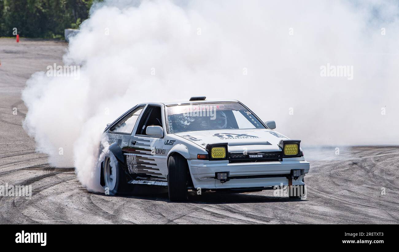 Car drifting auto racing event action with smoking tires - burning ...