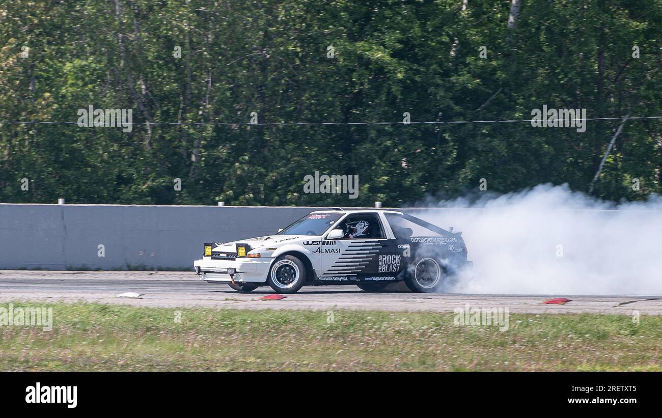 Car drifting auto racing event action with smoking tires - burning ...