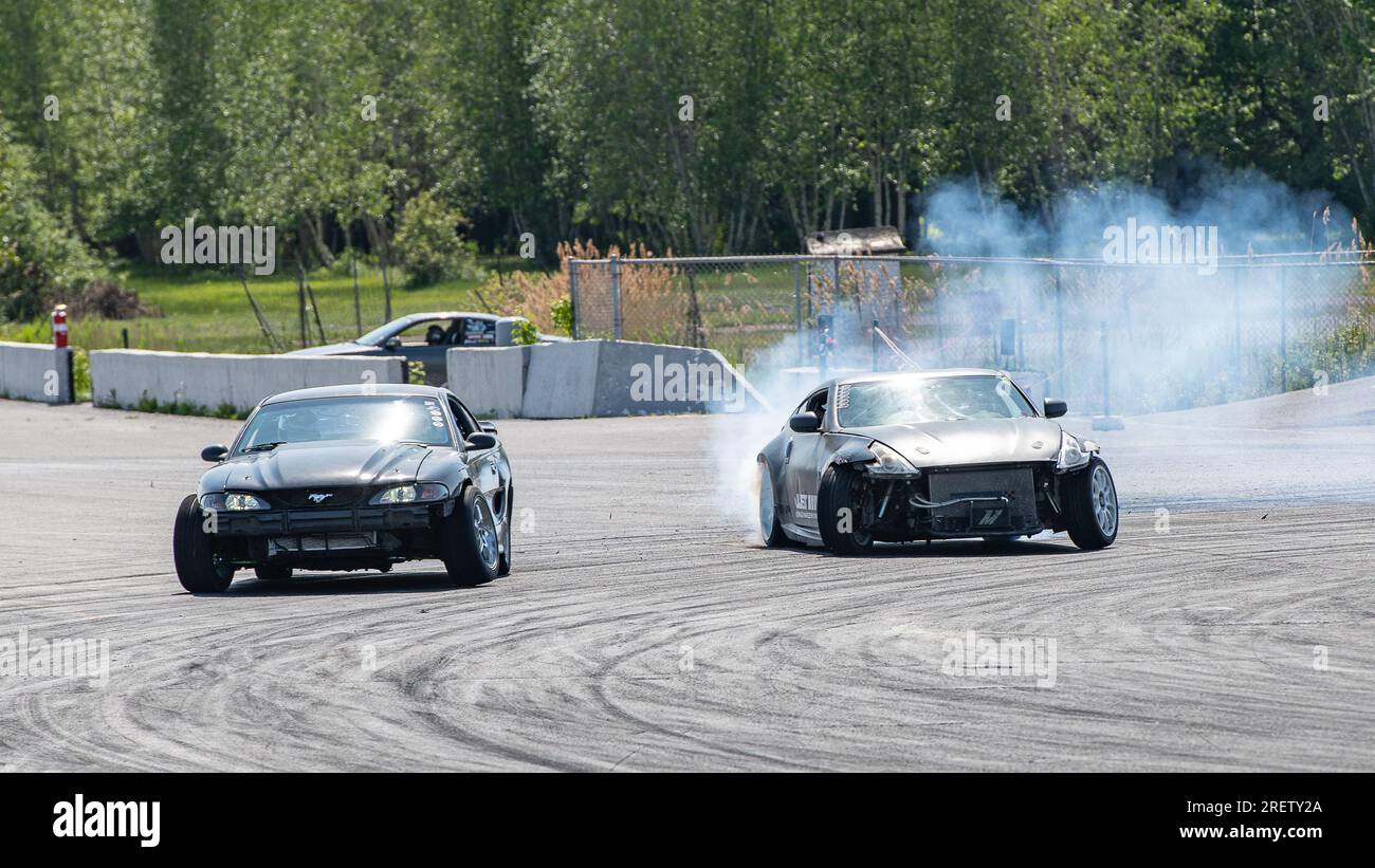 Car drifting auto racing event action with smoking tires - burning ...