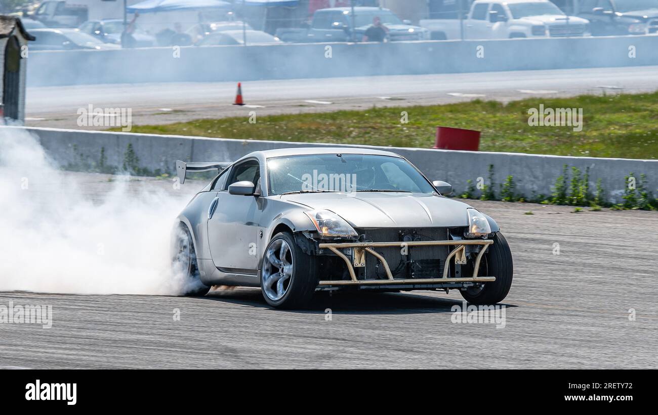 Car drifting auto racing event action with smoking tires - burning ...