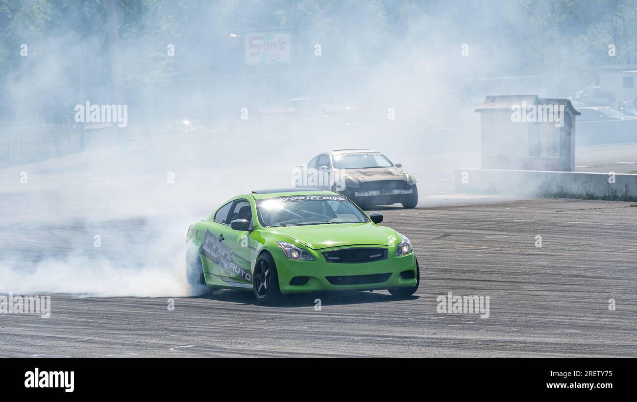 Car drifting auto racing event action with smoking tires - burning ...