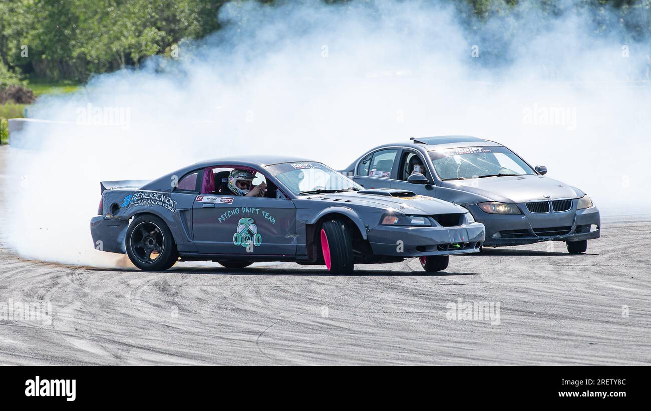Car drifting auto racing event action with smoking tires - burning ...