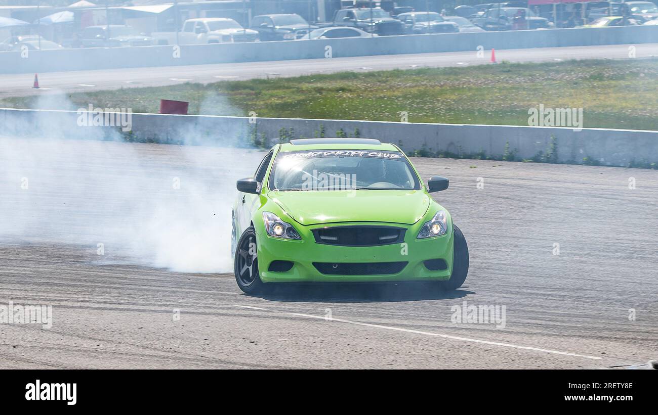 Car drifting auto racing event action with smoking tires - burning ...