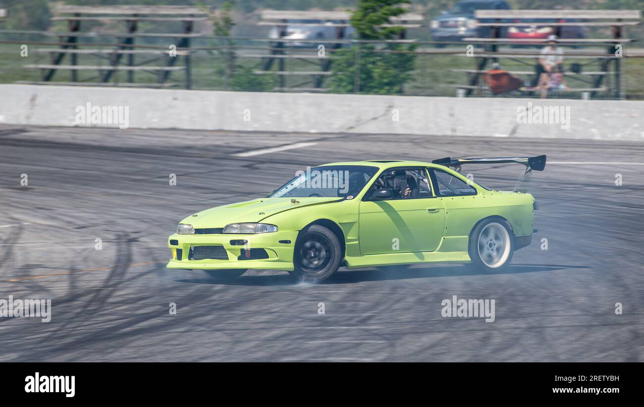 Car drifting auto racing event action with smoking tires - burning ...