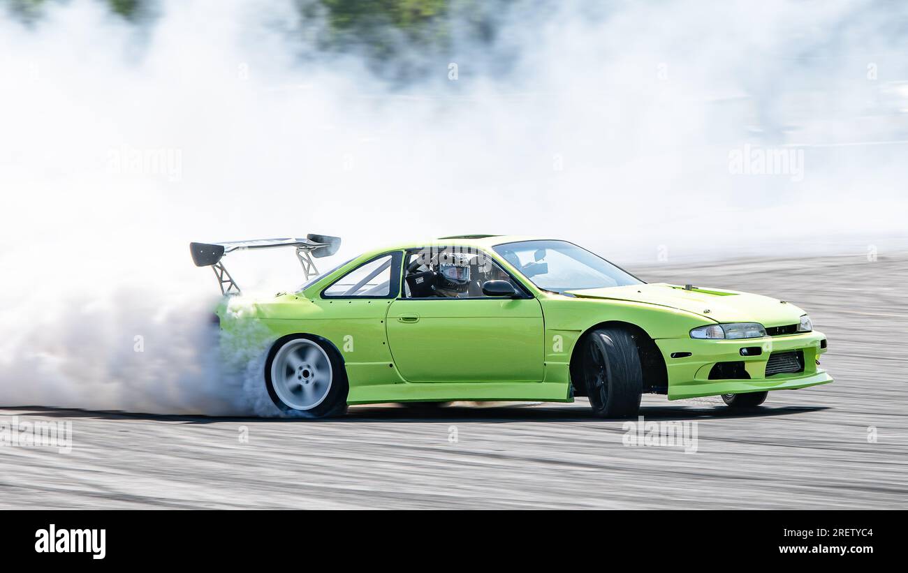 Car drifting auto racing event action with smoking tires - burning ...