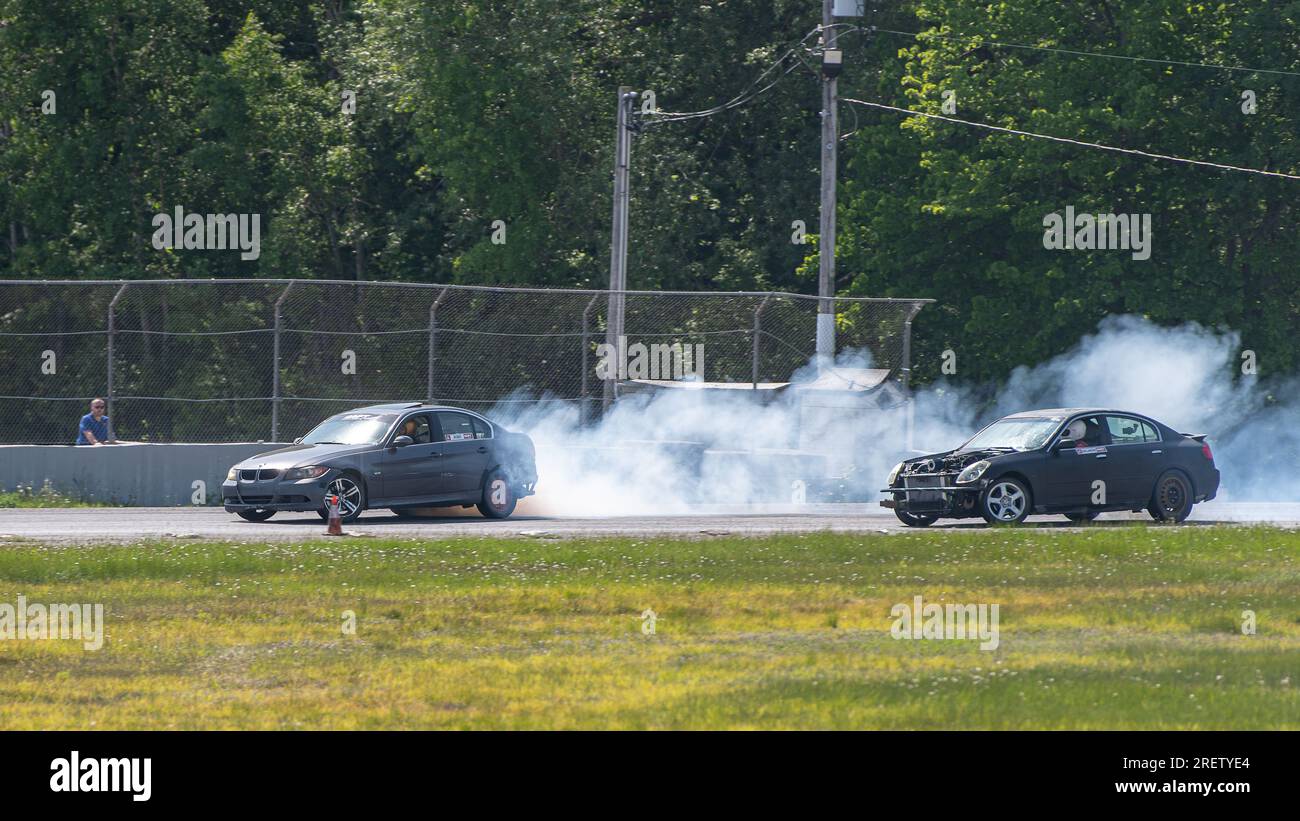 Car drifting auto racing event action with smoking tires - burning ...