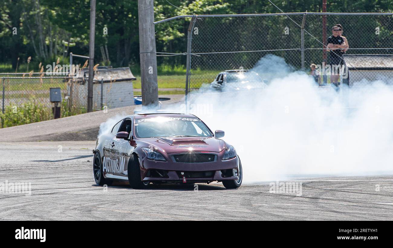 Car drifting auto racing event action with smoking tires - burning ...