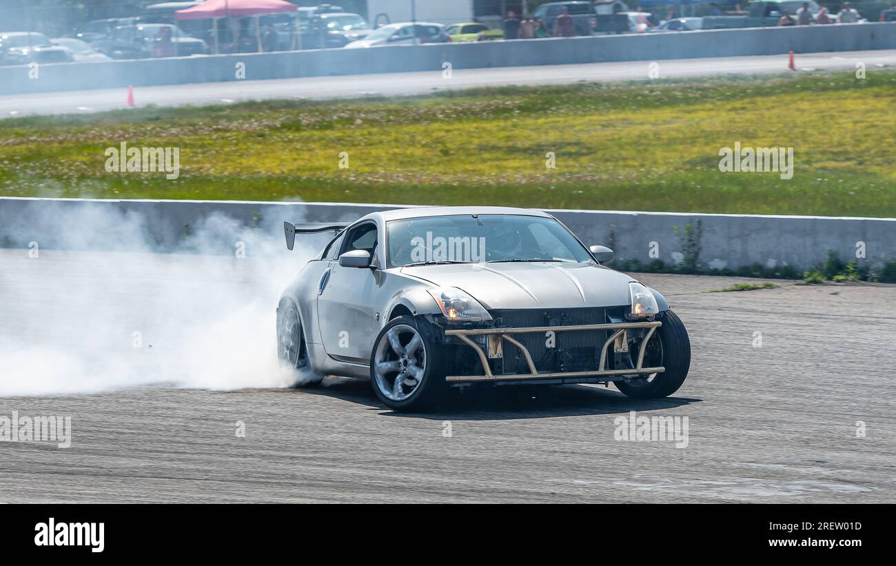 Car drifting auto racing event action with smoking tires - burning ...