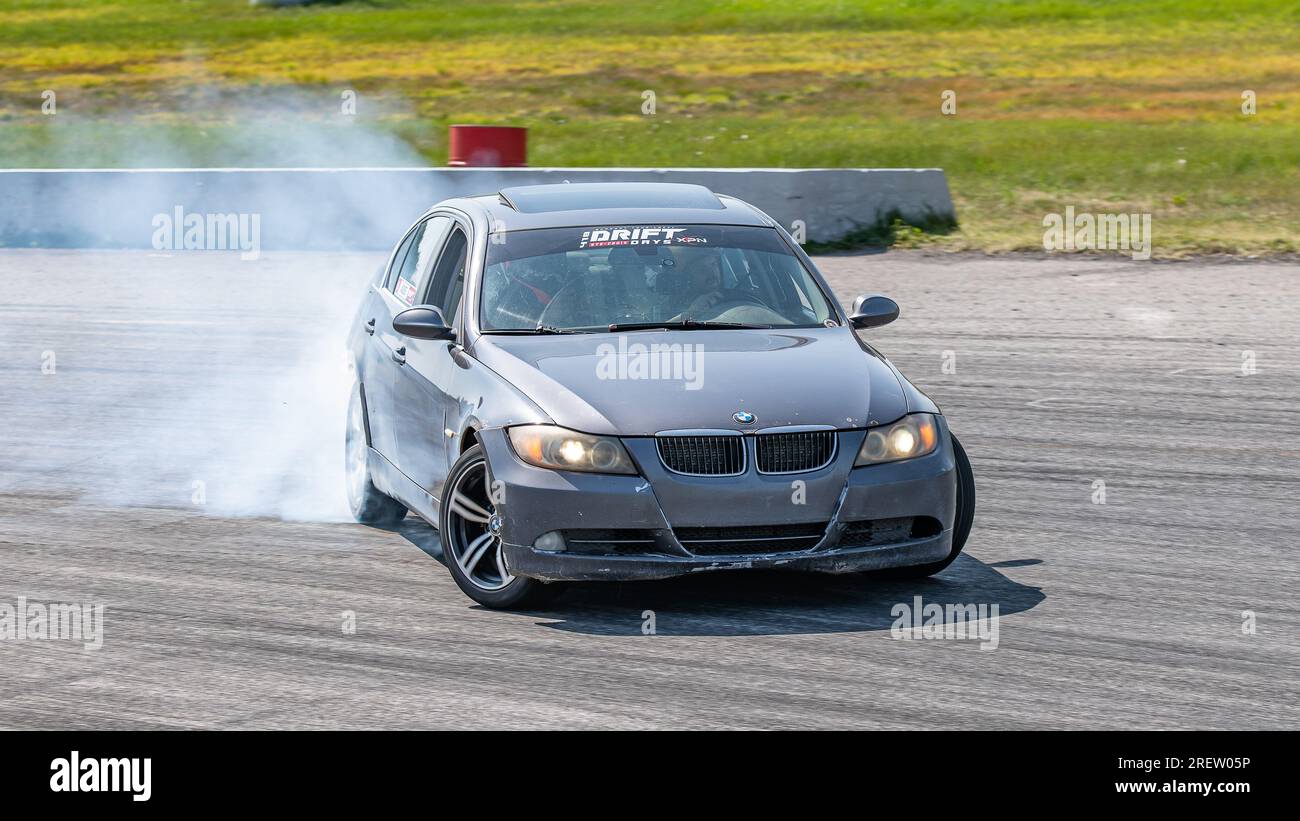 Car drifting auto racing event action with smoking tires - burning ...