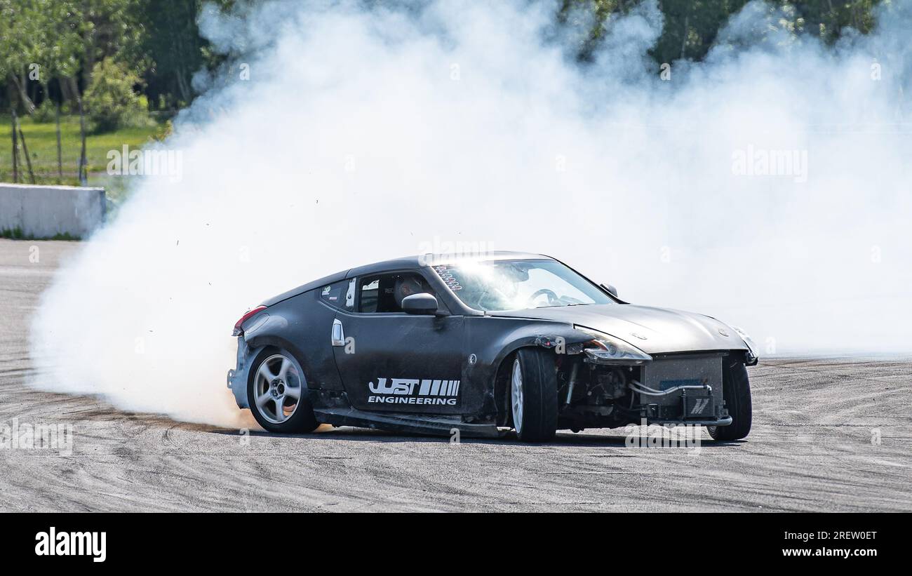 Car drifting auto racing event action with smoking tires - burning ...