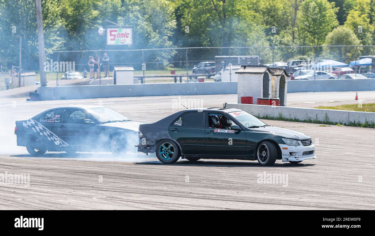 Car drifting auto racing event action with smoking tires - burning ...