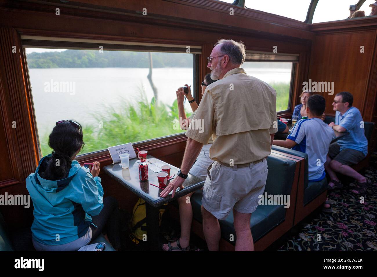 Travellers are looking at the nature from the train owned by the company the Panama Canal Railway, between Panama City and Colon, Republic of Panama Stock Photo