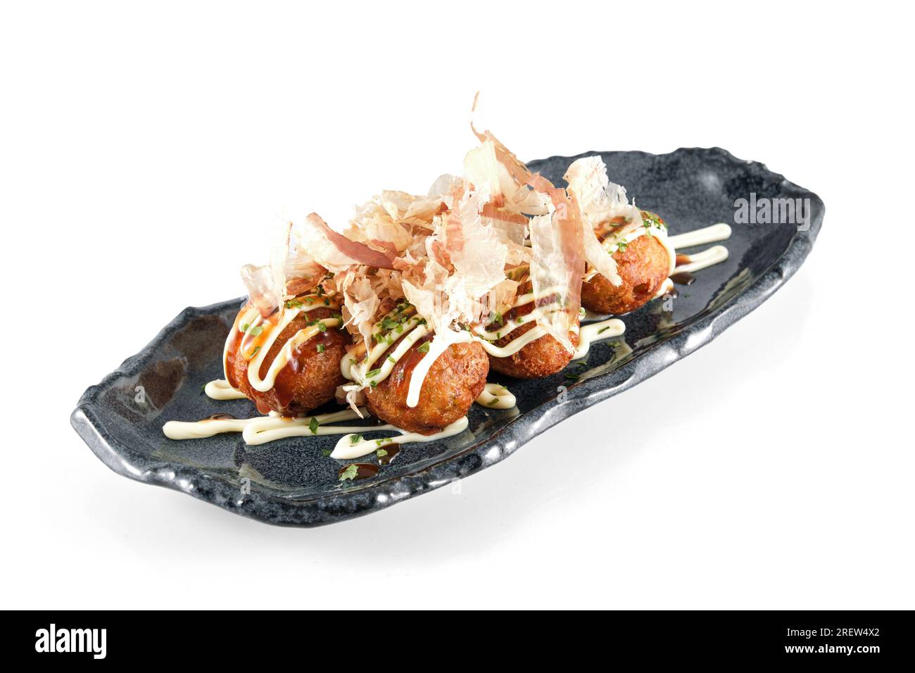 Plate with Japanese deep fried wheat octopus balls of Takoyaki topped