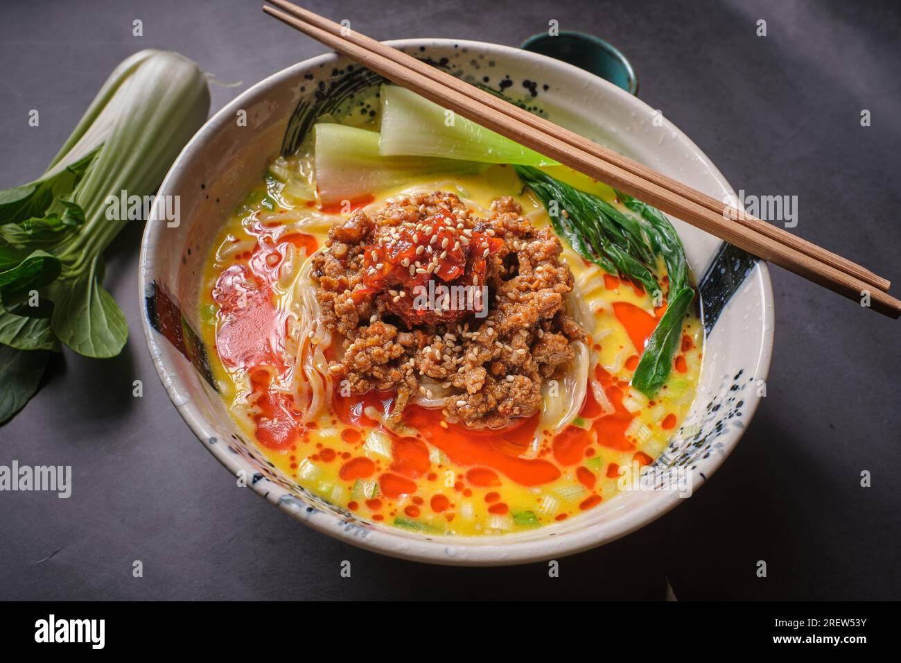 Stock photo of yummy noodles soup with minced meat isolated in grey background. Stock Photo