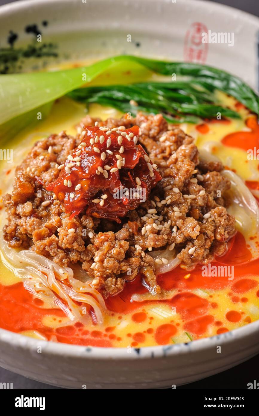 Stock photo of yummy japanese soup with noodles, minced meat and sesame seeds. Stock Photo