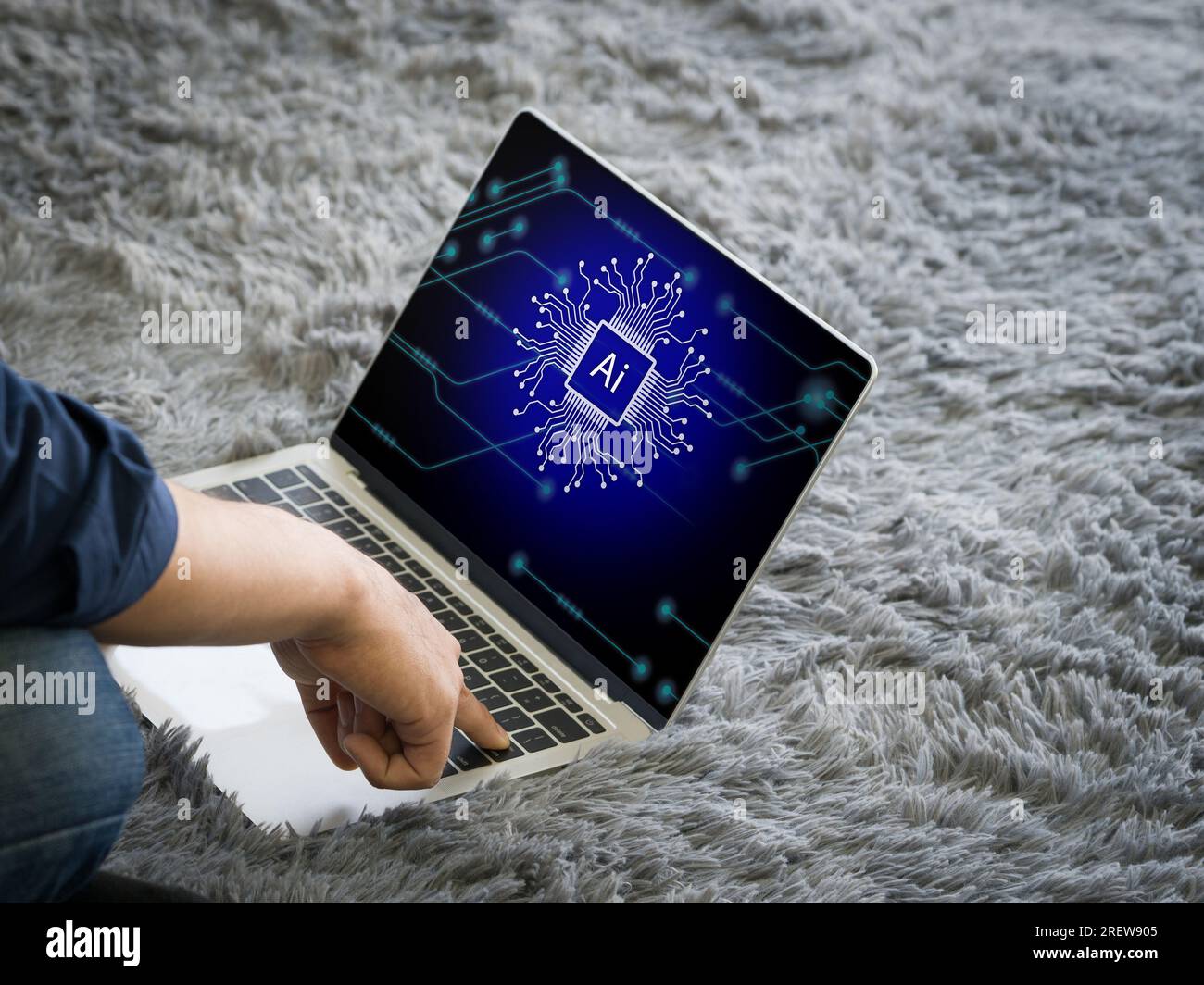 An individual engaged in work on a laptop, distinguished by a clearly visible AI cryptographic symbol. Stock Photo