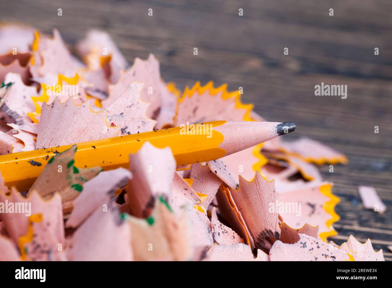 pencil shavings after sharpening, wood debris and parts of pencil lead after sharpening with a