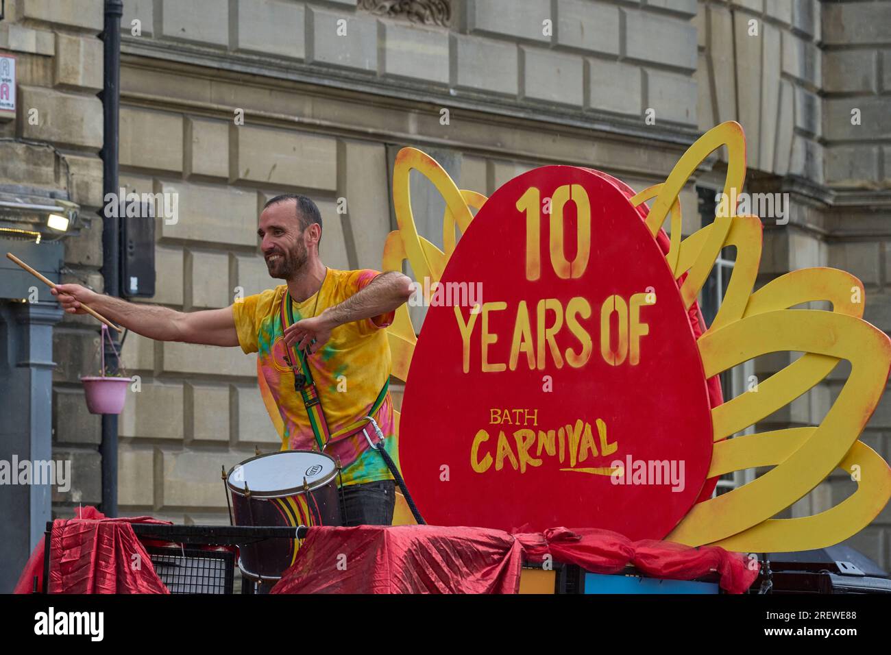 Dancers and musicians dressed in ornate costumes parade through the