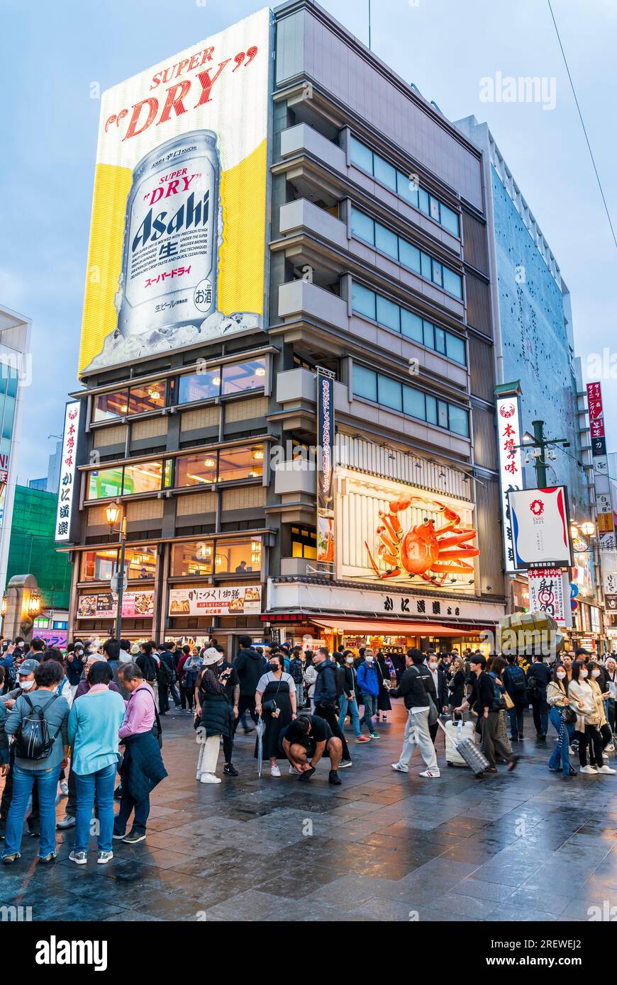 The popular Kani Doraku restaurant with its famous mechanical crab sign above the main entrance and the neon berry can sign at Dotonbori, Osaka. Night. Stock Photo