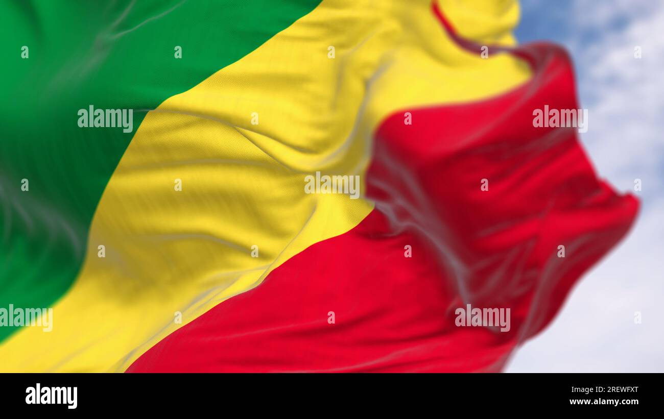 Republic of the Congo national flag waving in the wind on a clear day. Diagonal tricolor with green, yellow, and red stripes. 3d illustration render. Stock Photo