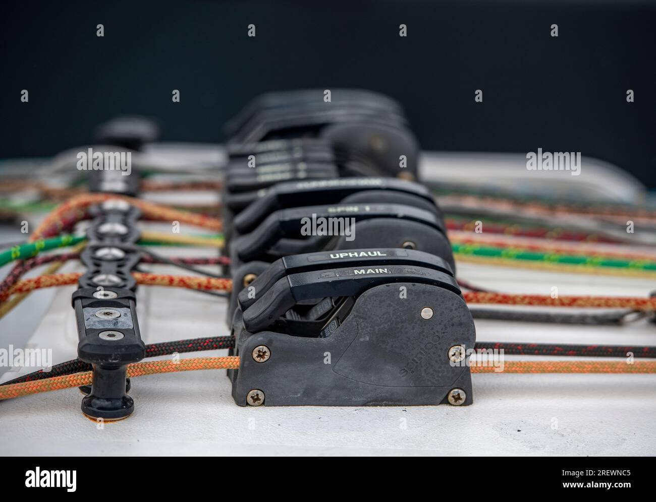 multi-coloured sailing ropes running through rope clutches. rope clutches on a racing yacht. racing yacht line management. Stock Photo