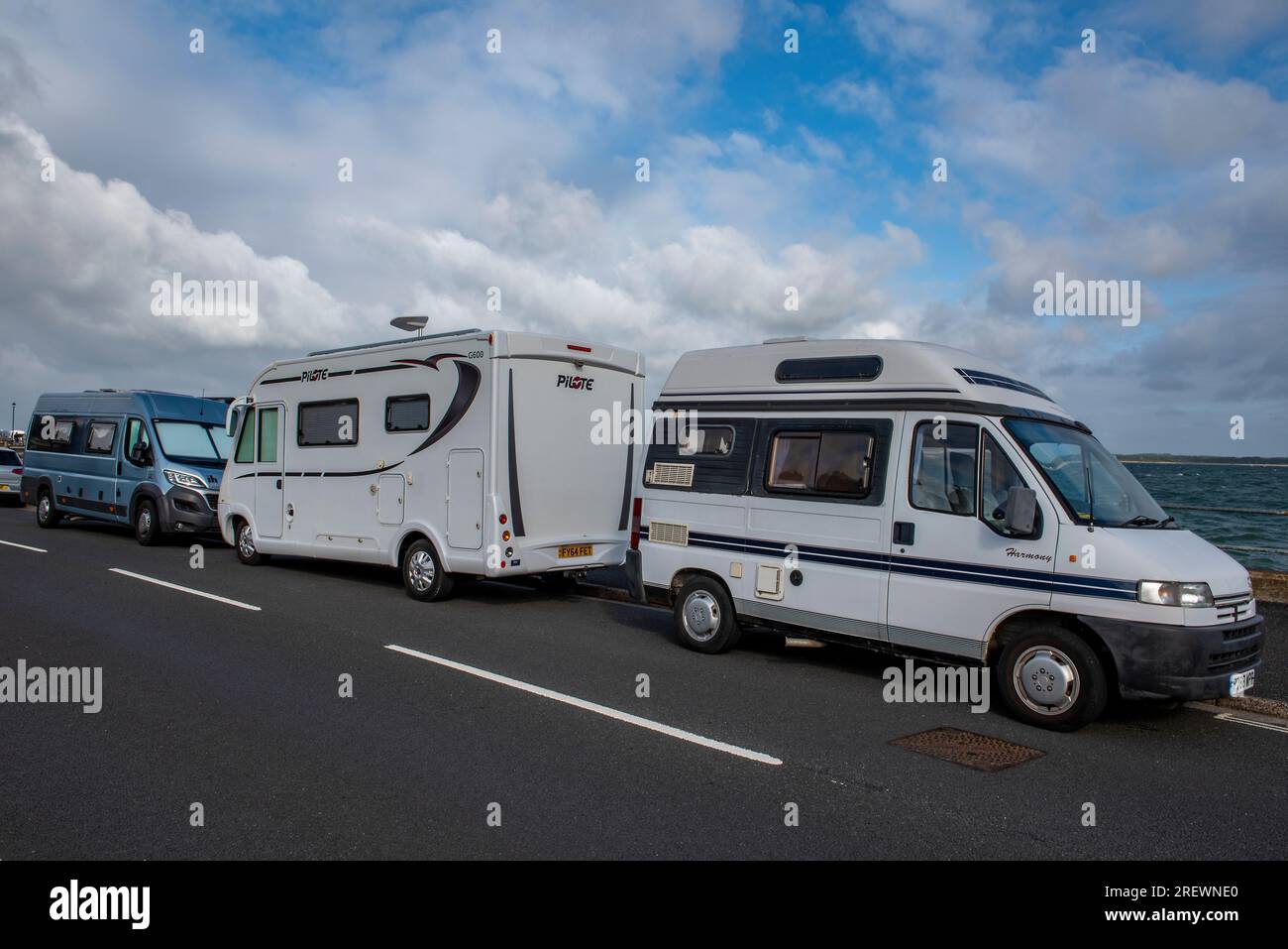 campervans and motorhomes parked at the seaside on the roadside Stock