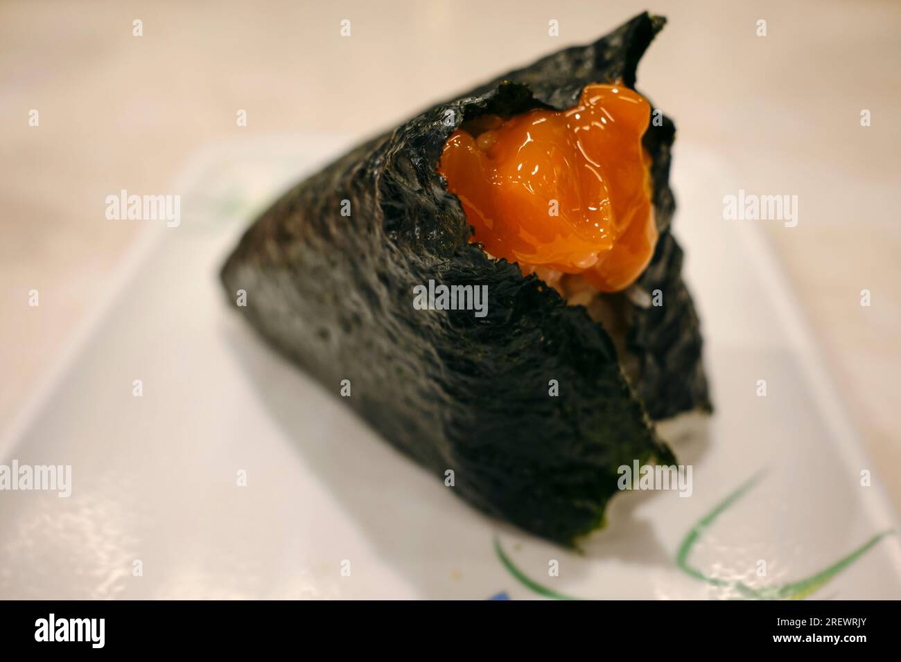 July 2023, Japanese rice ball (onigiri) with raw egg yolk marinated in