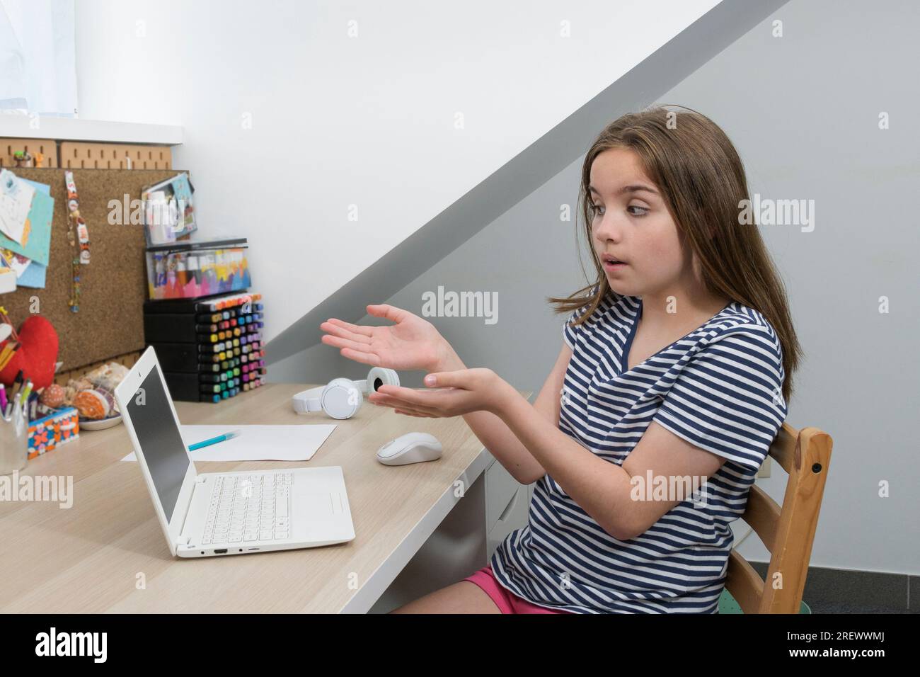 A teenager points to a non-working computer. Homework not done Stock Photo