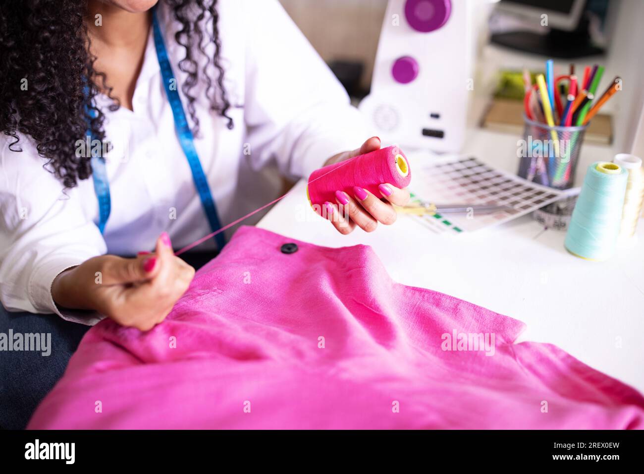 Seamstress Woman Choosing Thread Sitting Near Sewing Machine Indoor ...