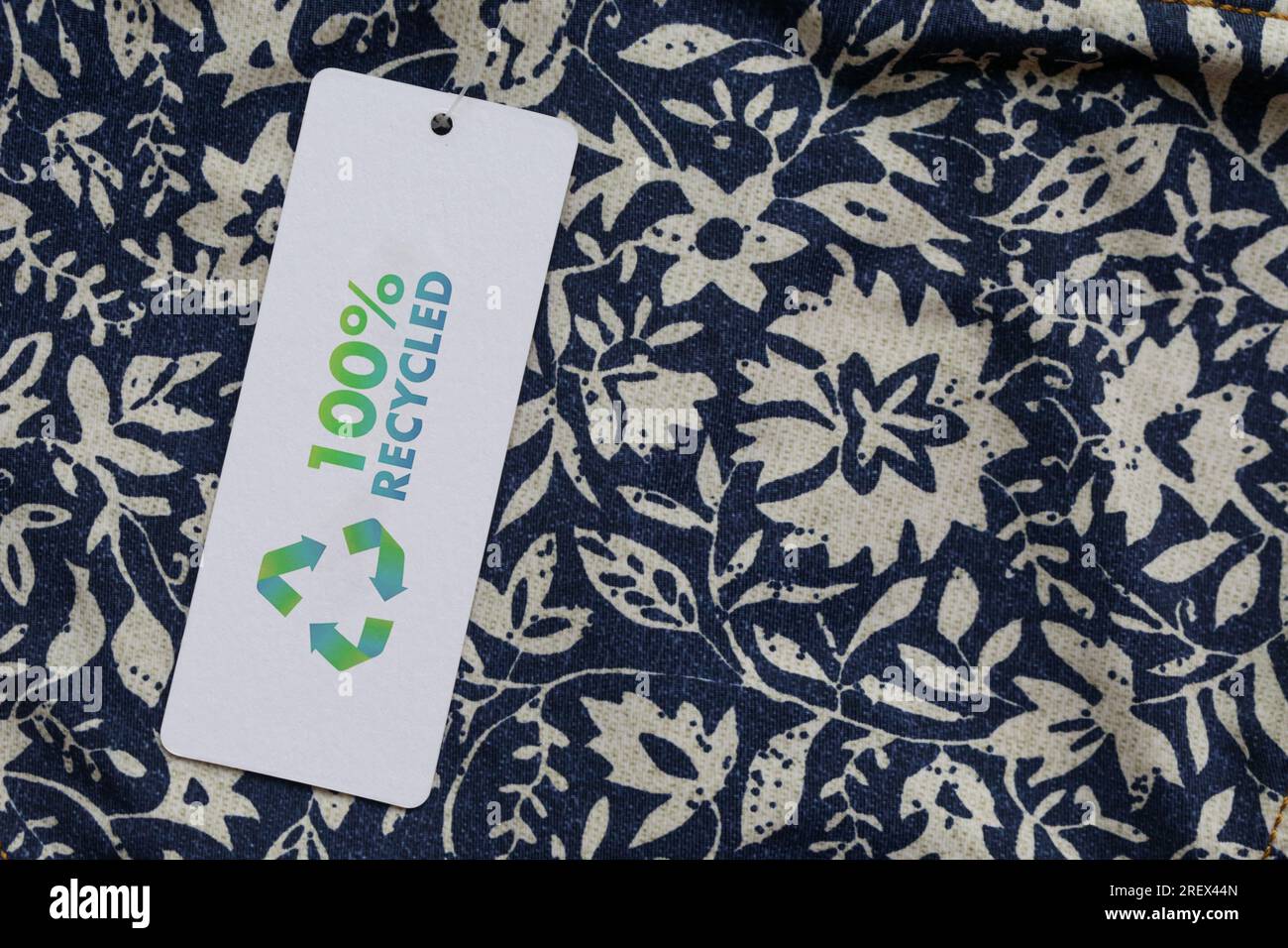 Close up of clothing tag with recycle icon. Recycling products concept