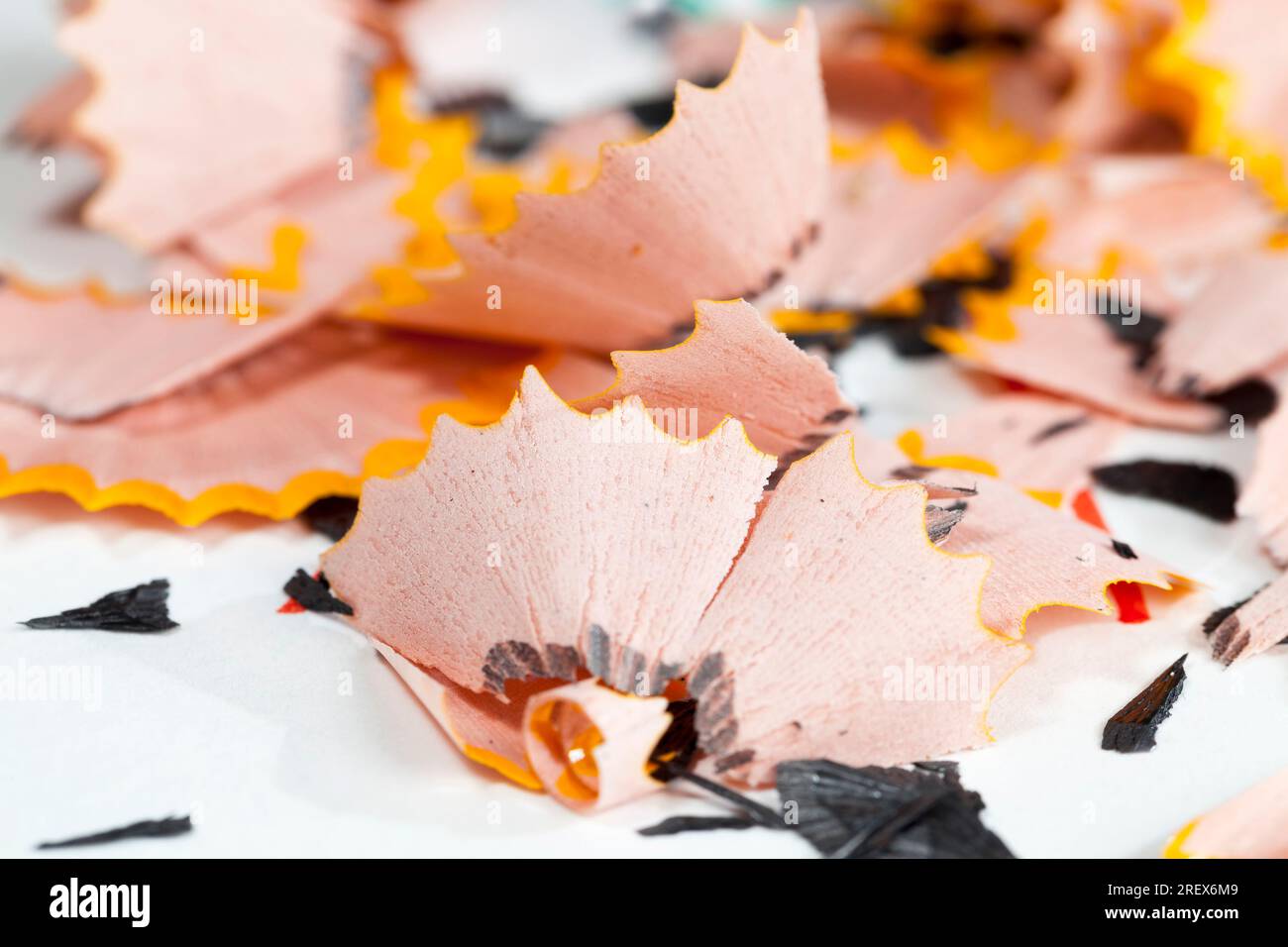 pencil shavings after sharpening, wood debris and parts of pencil lead