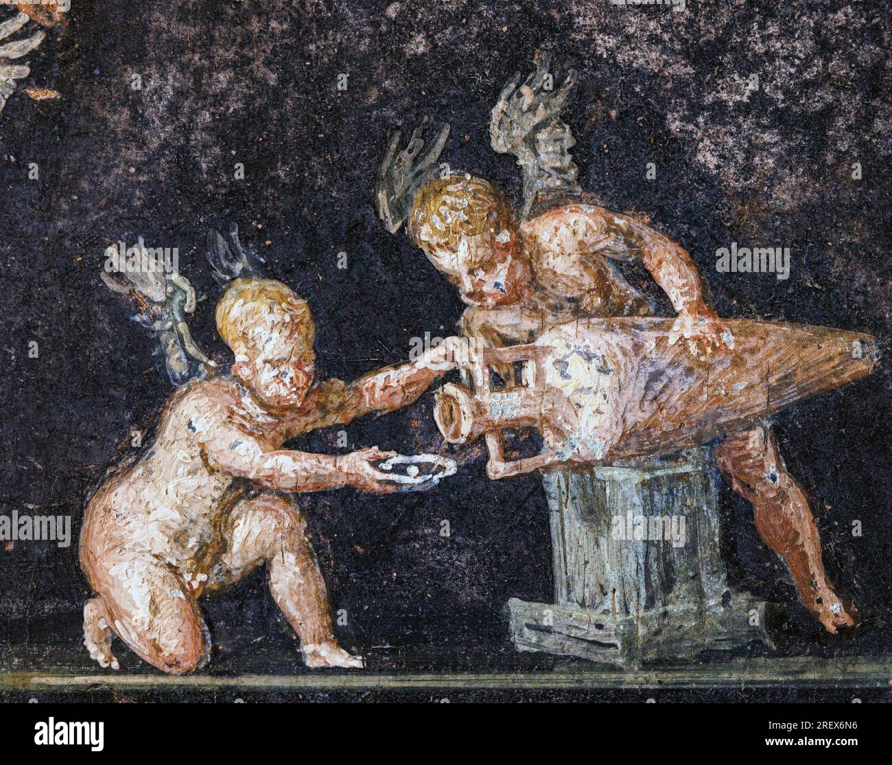 Pompeii Archaeological Site, Campania, Italy.  House of the Vettii.  Casa dei Vettii.  Fresco of Cupids tasting wine.  Pompeii, Herculaneum, and Torre Stock Photo