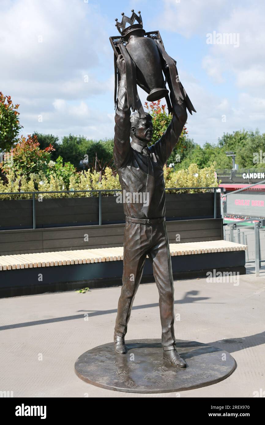 London, UK. 30 July 2023. Arsenal unveil Arsène Wenger statue outside the Emirates Stadium to commemorate the Gunners iconic manager's 22-year tenure at the club. The legendary manager led Arsenal FC to three Premier League titles, including the famous Invincibles season in 2003/04 where his side remained unbeaten, and seven FA Cups. The bronze statue, which was created by sculptor Jim Guy, is 3.5 metres high and weighs approximately half a tonne, and depicts the former French manager lifting the Premier League trophy. Credit: Waldemar Sikora/Alamy Live News Stock Photo