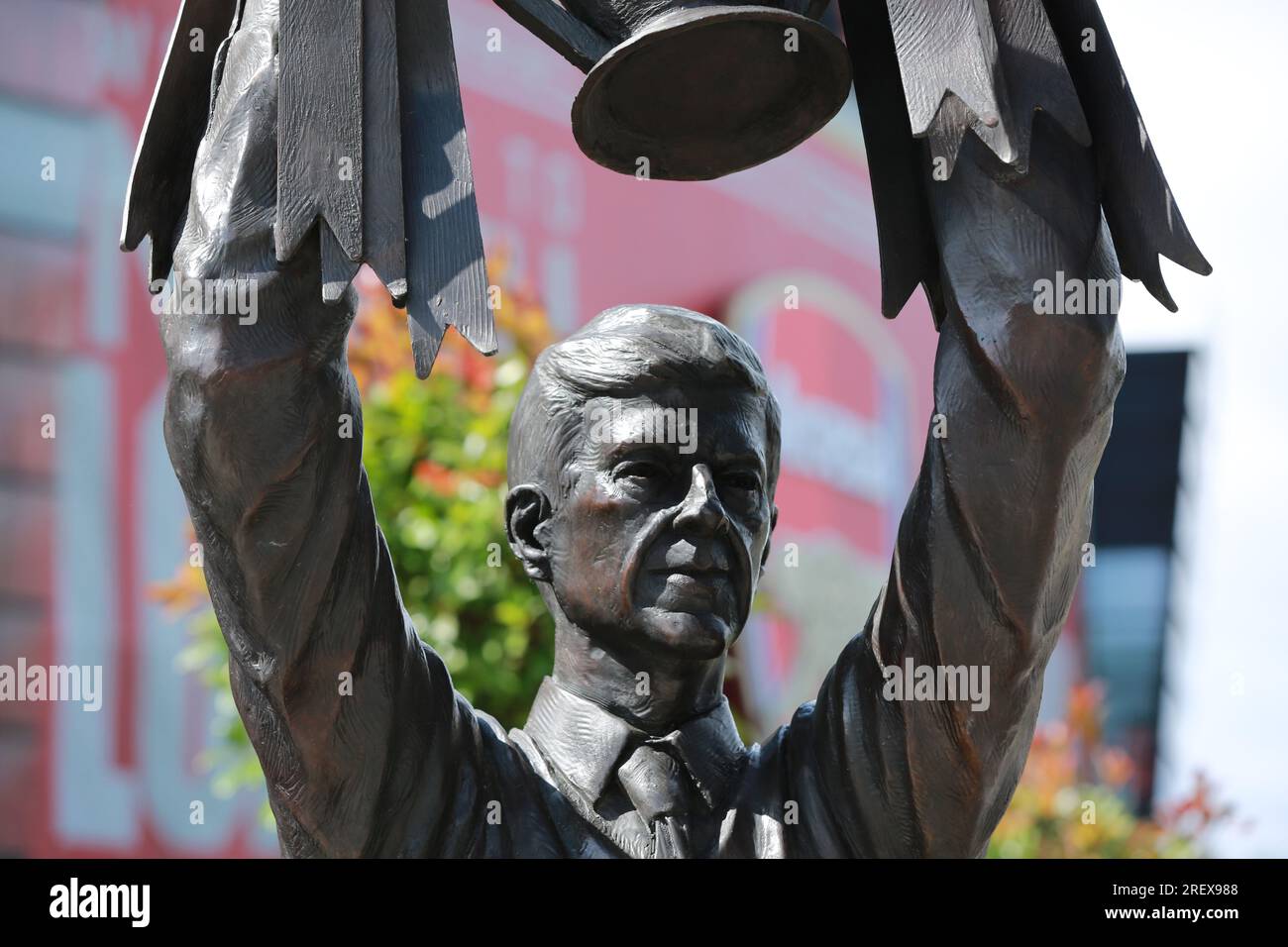 London, UK. 30 July 2023. Arsenal unveil Arsène Wenger statue outside the Emirates Stadium to commemorate the Gunners iconic manager's 22-year tenure at the club. The legendary manager led Arsenal FC to three Premier League titles, including the famous Invincibles season in 2003/04 where his side remained unbeaten, and seven FA Cups. The bronze statue, which was created by sculptor Jim Guy, is 3.5 metres high and weighs approximately half a tonne, and depicts the former French manager lifting the Premier League trophy. Credit: Waldemar Sikora/Alamy Live News Stock Photo