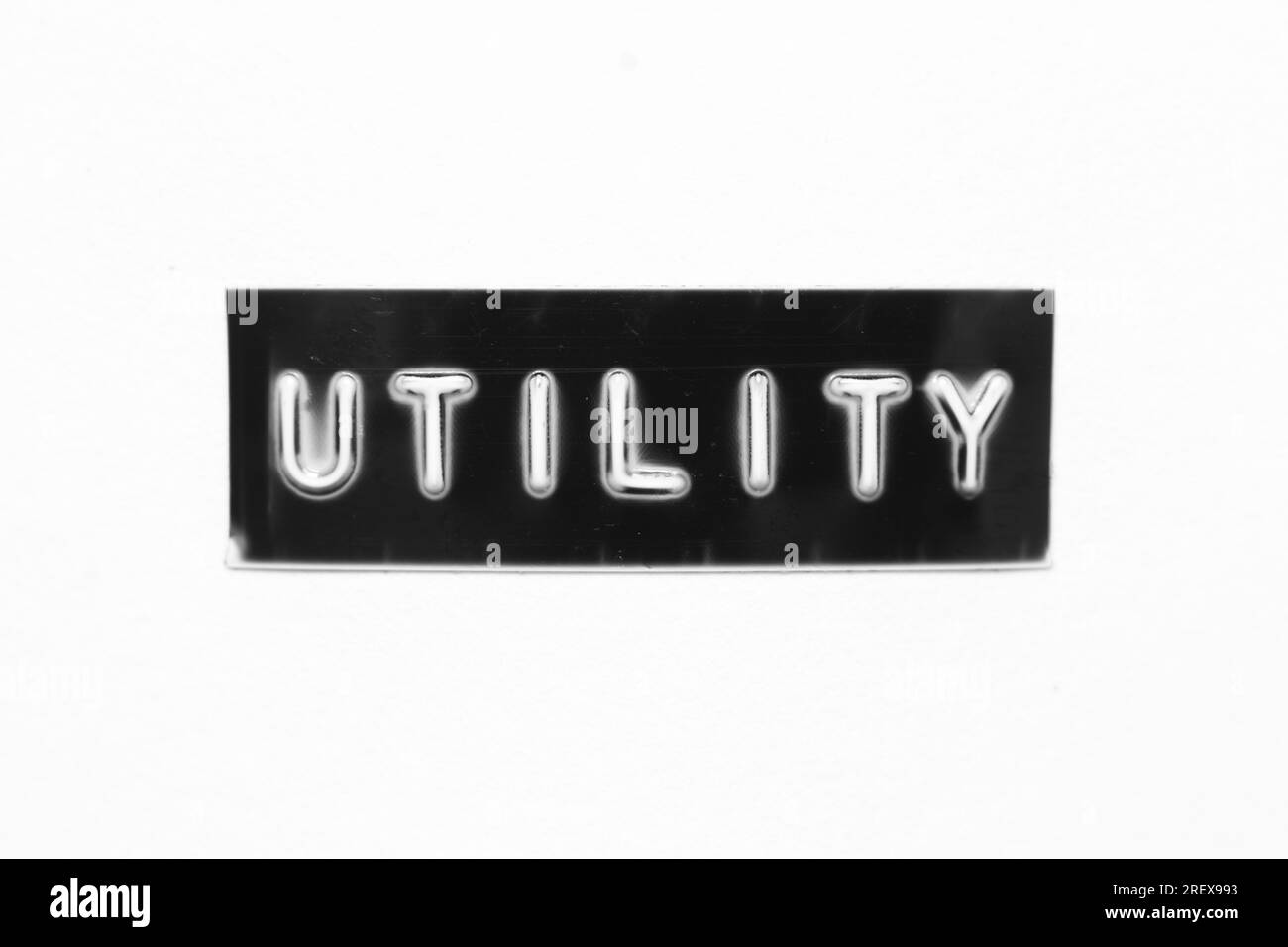 Black color banner that have embossed letter with word utility on white