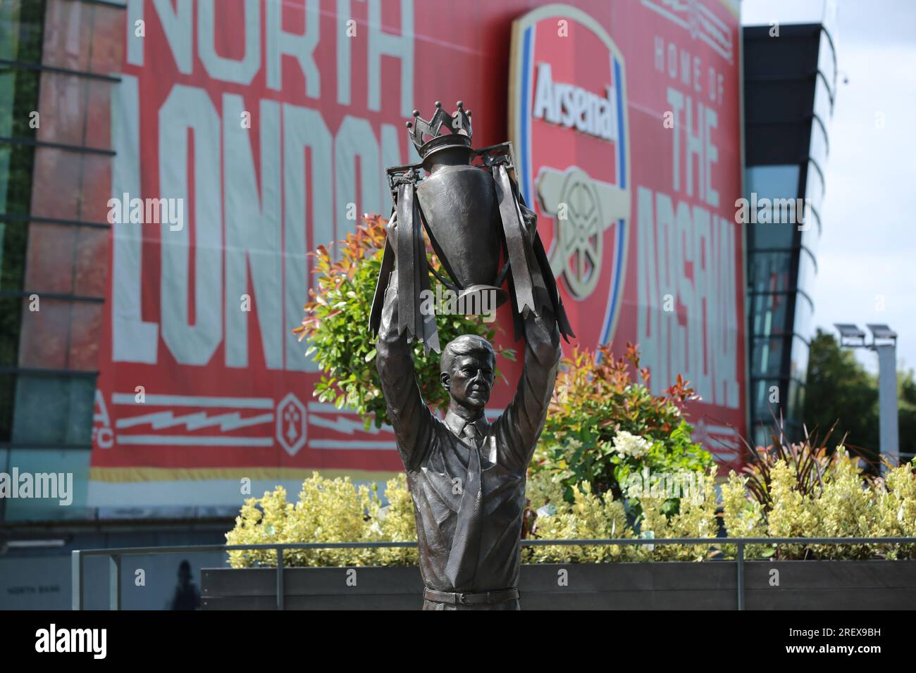 London, UK. 30 July 2023. Arsenal unveil Arsène Wenger statue outside the Emirates Stadium to commemorate the Gunners iconic manager's 22-year tenure at the club. The legendary manager led Arsenal FC to three Premier League titles, including the famous Invincibles season in 2003/04 where his side remained unbeaten, and seven FA Cups. The bronze statue, which was created by sculptor Jim Guy, is 3.5 metres high and weighs approximately half a tonne, and depicts the former French manager lifting the Premier League trophy. Credit: Waldemar Sikora/Alamy Live News Stock Photo