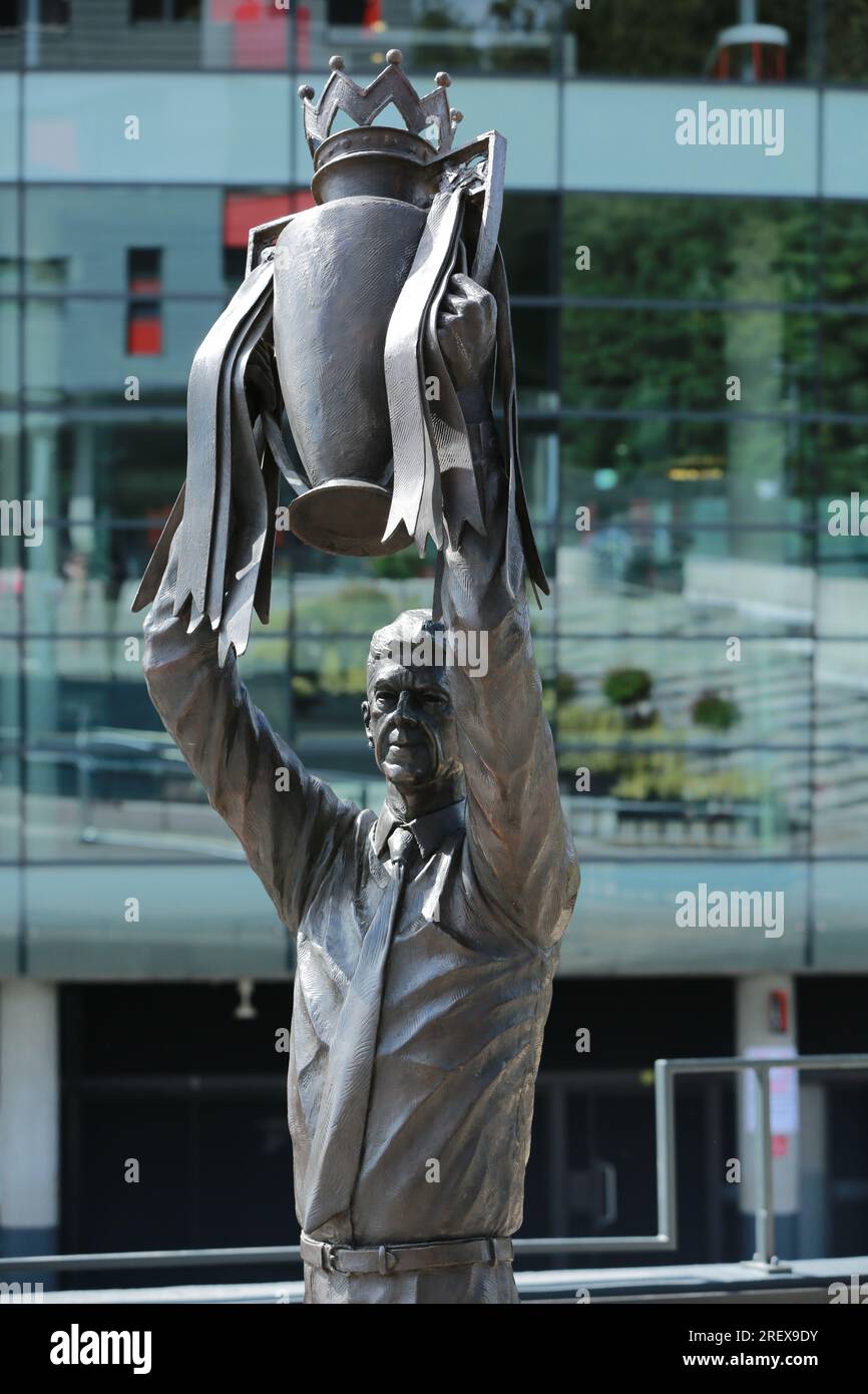 London, UK. 30 July 2023. Arsenal unveil Arsène Wenger statue outside the Emirates Stadium to commemorate the Gunners iconic manager's 22-year tenure at the club. The legendary manager led Arsenal FC to three Premier League titles, including the famous Invincibles season in 2003/04 where his side remained unbeaten, and seven FA Cups. The bronze statue, which was created by sculptor Jim Guy, is 3.5 metres high and weighs approximately half a tonne, and depicts the former French manager lifting the Premier League trophy. Credit: Waldemar Sikora/Alamy Live News Stock Photo