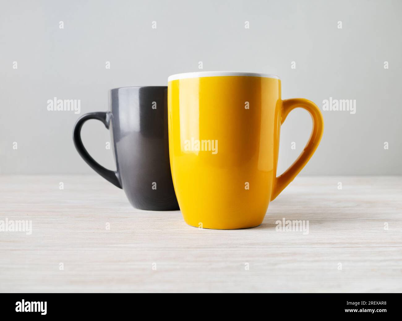 Two blank tea cups or coffee mugs. Responsive design mockup. Selective focus. Stock Photo