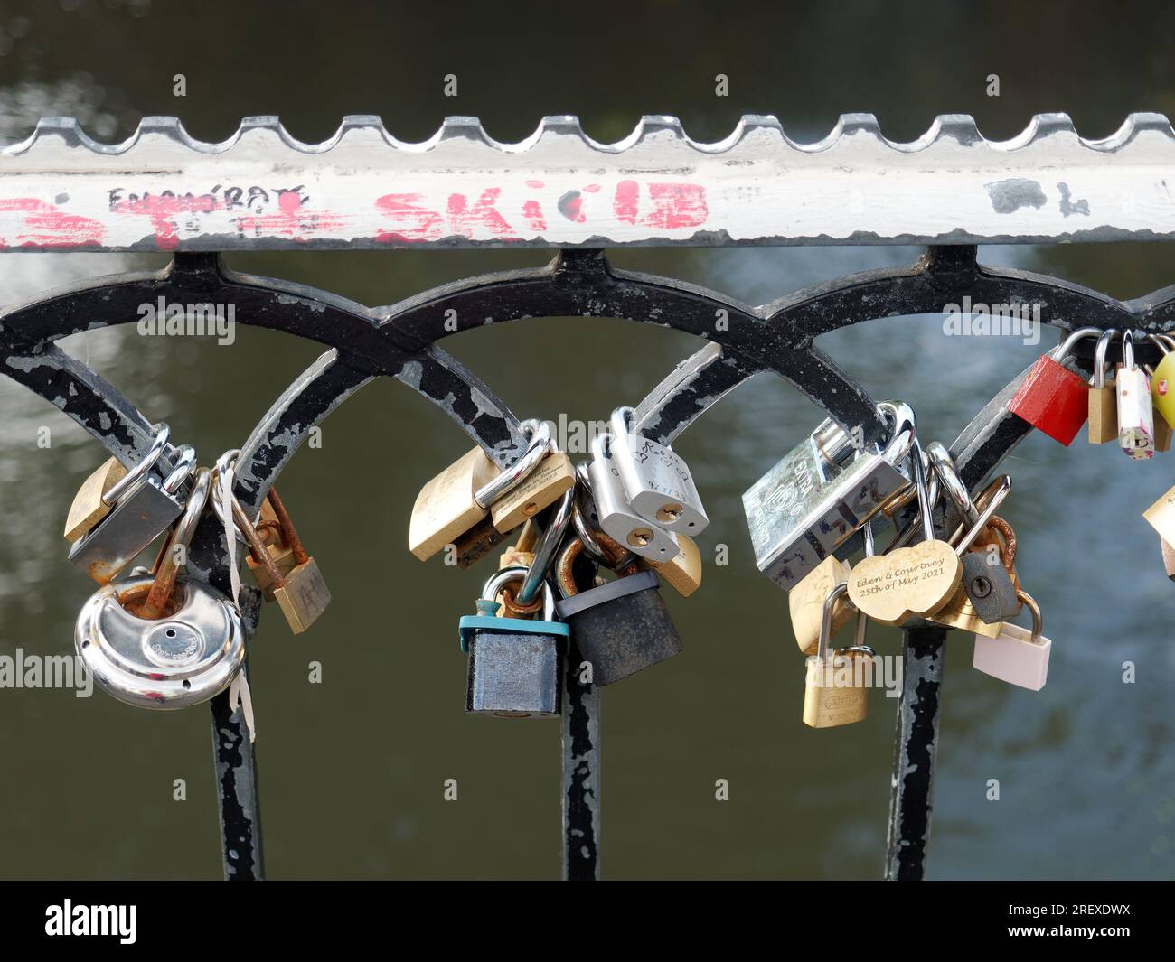 Closeup view of padlocks with sentimental messages attached to metal