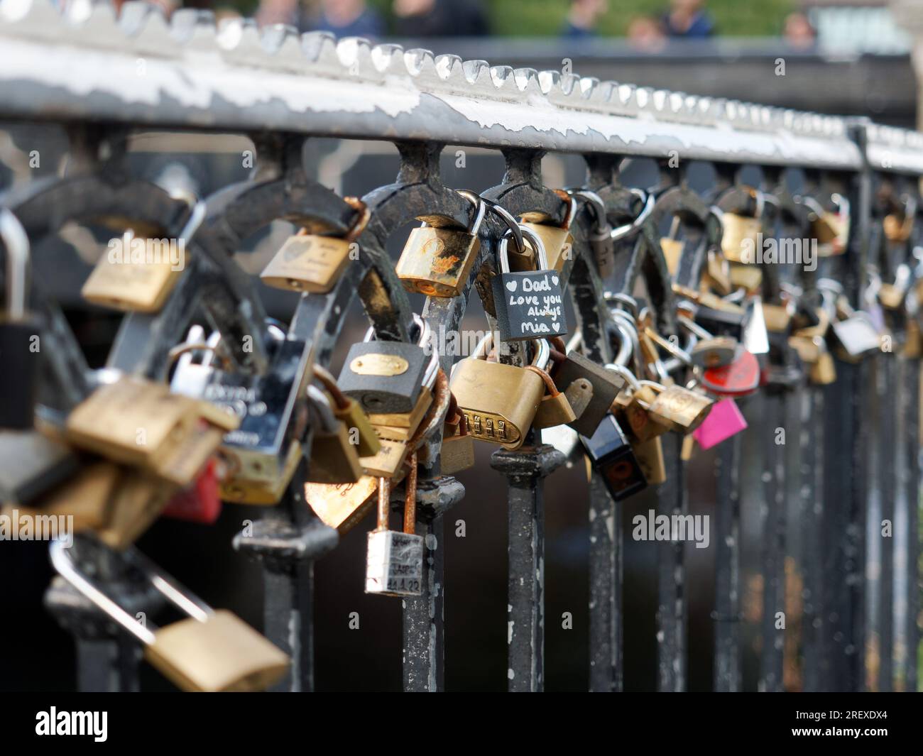 Closeup view of line of padlocks with sentimental messages attached to
