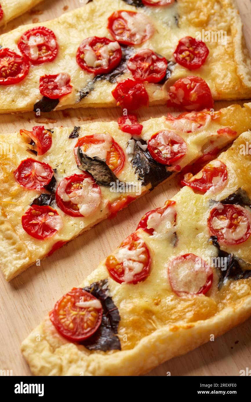 Puff pastry tart with cherry tomatoes, mozzarella and purple basil