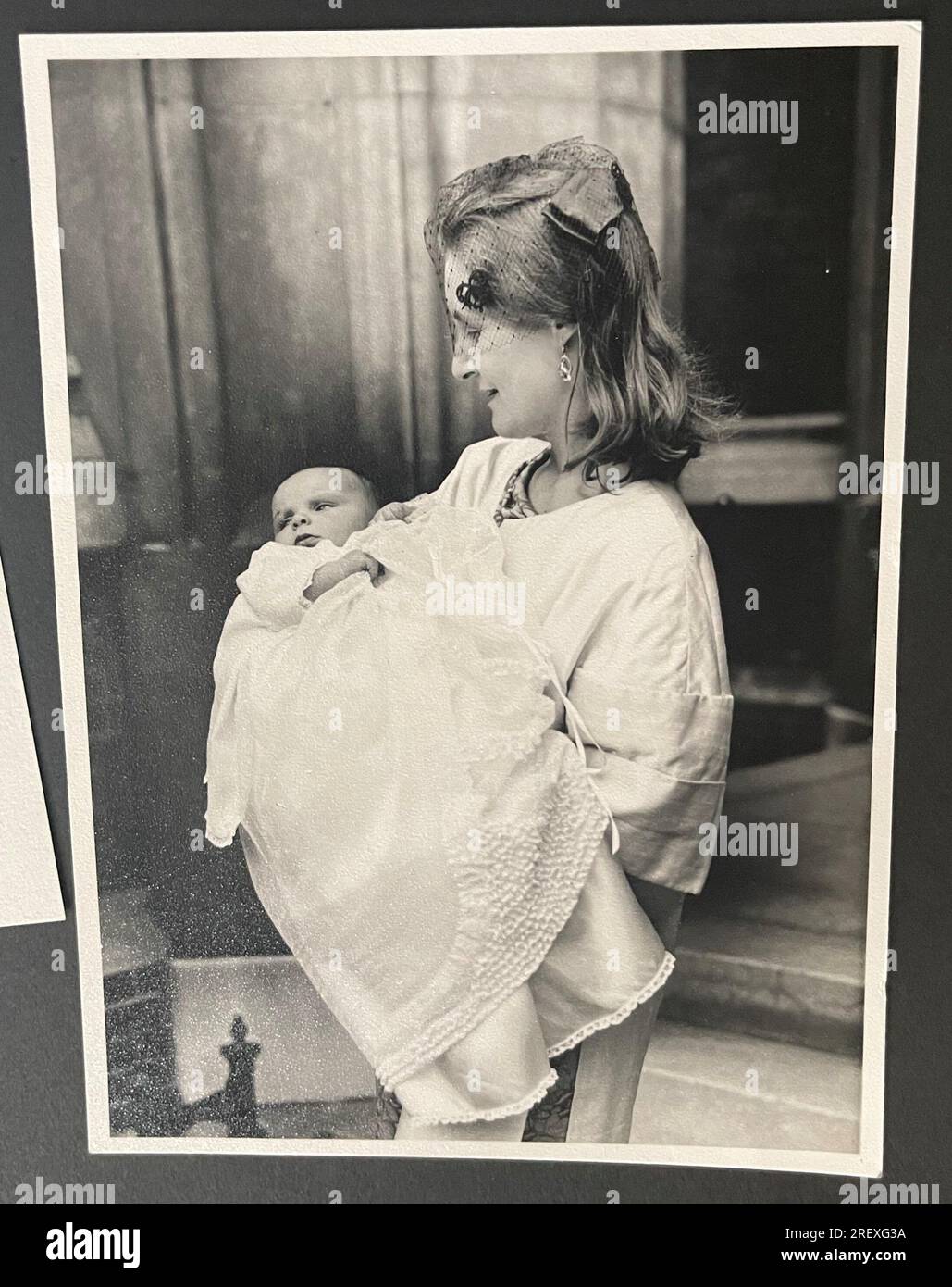 Vintage black and white photo of woman holding baby at christening 1950. Stock Photo