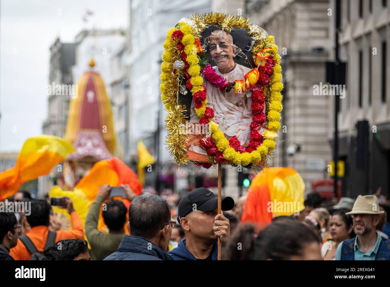 London, UK.  30 July 2023.  Hare Krishna devotees with a sign showing their founder Bhaktivedanta Swani Prabhupada during the Rathayatra Festival, or Festival of the Chariots, pass through Piccadilly.  Usually three decorated chariots, carrying the deity forms of Jagannatha, Baladeva and Subhadra, are wheeled from Hyde Park to Trafalgar Square, but this year due to space restrictions in the square, only one chariot is permitted.  Once in the square, devotees enjoy free vegetarian food and refreshments during the festival.   Credit: Stephen Chung / Alamy Live News Stock Photo