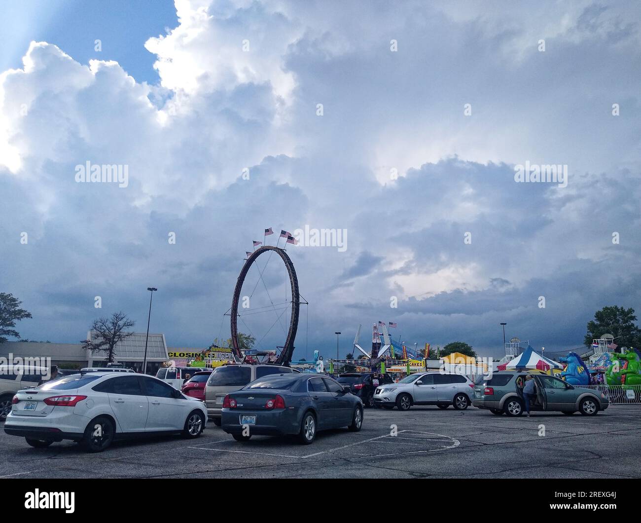 Carnival-goers retreat to their vehicles as a heavy thunderstorm rolls in on Saturday, July 30, 2020 at Towne Square Mall in Owensboro, Daviess County, KY, USA. Total rain accumulation for the day was approximately 1.9 inches. (Apex MediaWire Photo by Billy Suratt) Stock Photo