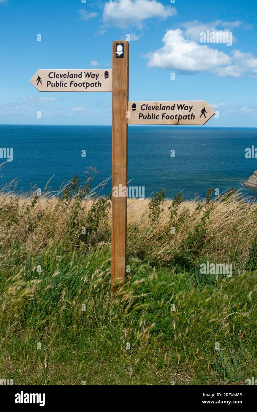 A sighnpost showing directions on the Cleveland Way on the cliff above Kettleness North Yorkshire Stock Photo