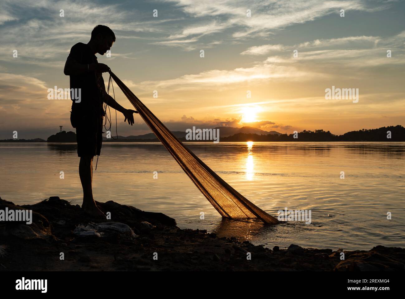 Guwahati, India. 30th July 2023. A fisherman fishing in the Brahmaputra river during sunset in