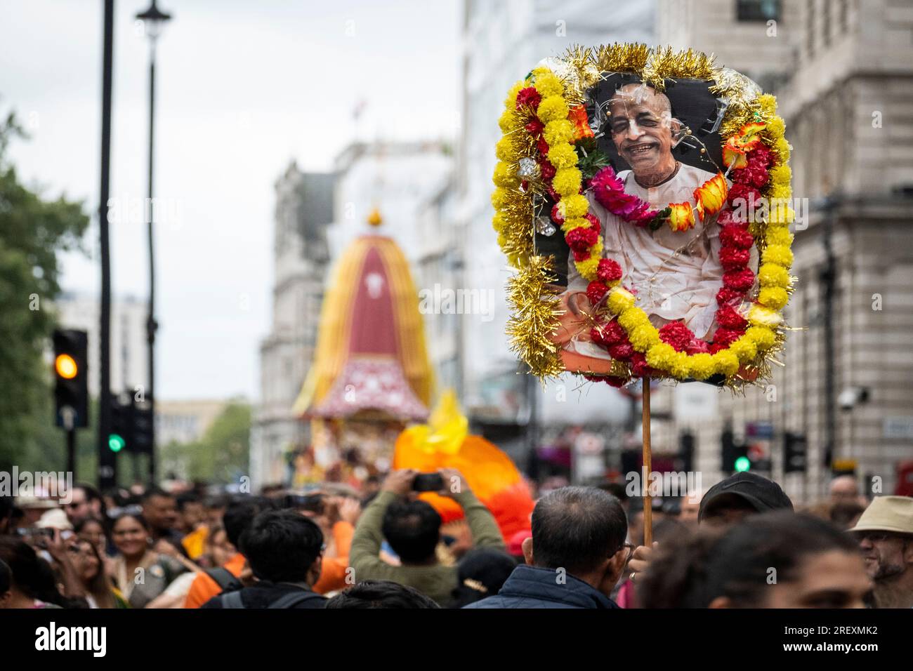 London, UK.  30 July 2023.  Hare Krishna devotees with a sign showing their founder Bhaktivedanta Swani Prabhupada during the Rathayatra Festival, or Festival of the Chariots, pass through Piccadilly.  Usually three decorated chariots, carrying the deity forms of Jagannatha, Baladeva and Subhadra, are wheeled from Hyde Park to Trafalgar Square, but this year due to space restrictions in the square, only one chariot is permitted.  Once in the square, devotees enjoy free vegetarian food and refreshments during the festival.   Credit: Stephen Chung / Alamy Live News Stock Photo